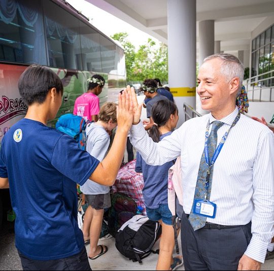 Rami greeting students returning from Malaysia Week